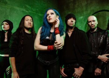 DragonForce band photo featuring Alissa White-Gluz, Herman Li, Sam Totman and full lineup against a dark backdrop.