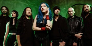 DragonForce band photo featuring Alissa White-Gluz, Herman Li, Sam Totman and full lineup against a dark backdrop.