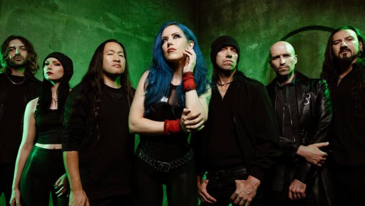 DragonForce band photo featuring Alissa White-Gluz, Herman Li, Sam Totman and full lineup against a dark backdrop.