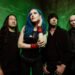 DragonForce band photo featuring Alissa White-Gluz, Herman Li, Sam Totman and full lineup against a dark backdrop.
