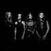 Black-and-white promo photo of Brazilian death metal band Crypta, four members in black leather posing against a dark background.