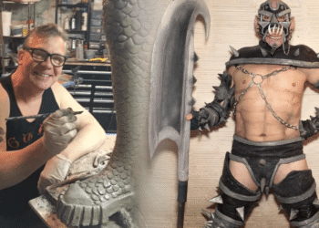 GWAR co-founder Chuck Varga Sexecutioner smiling while sculpting a scaly clay piece in his workshop, next to a performer in a spiked GWAR costume holding a giant axe