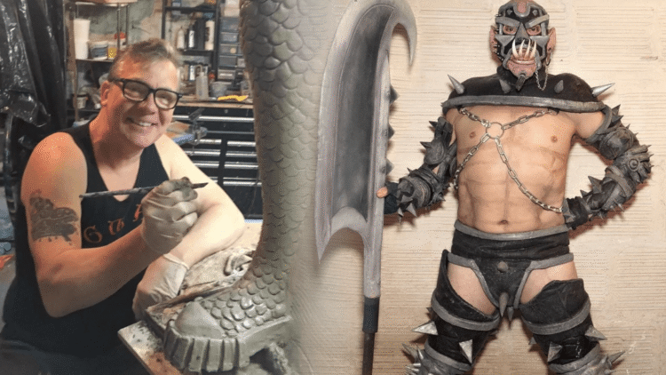 GWAR co-founder Chuck Varga Sexecutioner smiling while sculpting a scaly clay piece in his workshop, next to a performer in a spiked GWAR costume holding a giant axe