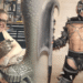 GWAR co-founder Chuck Varga Sexecutioner smiling while sculpting a scaly clay piece in his workshop, next to a performer in a spiked GWAR costume holding a giant axe